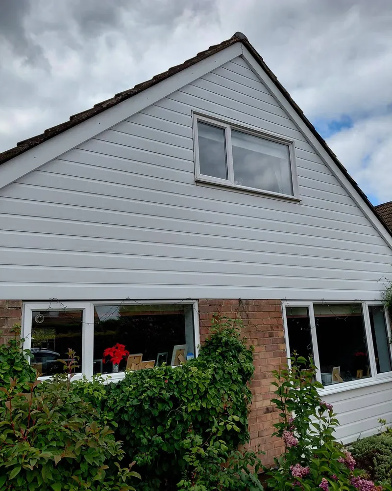 A house with clean white cladding and a clear window
