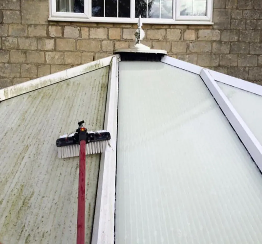 Conservatory roof half cleaned, clean on the right and green on the left