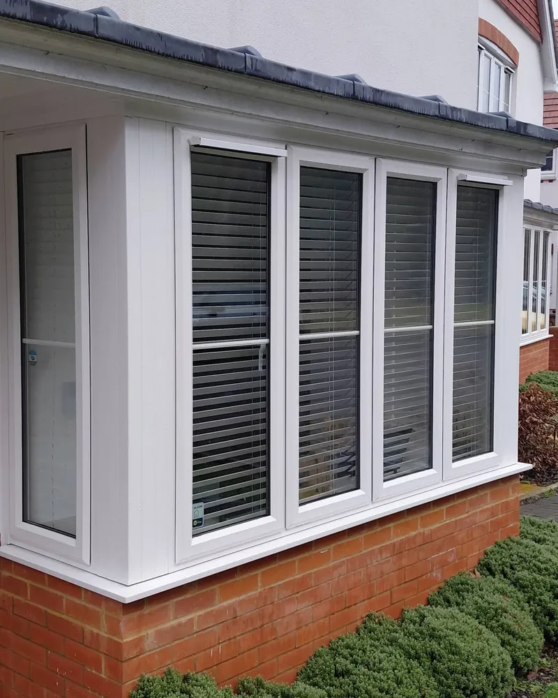 Clean white bay window with blinds